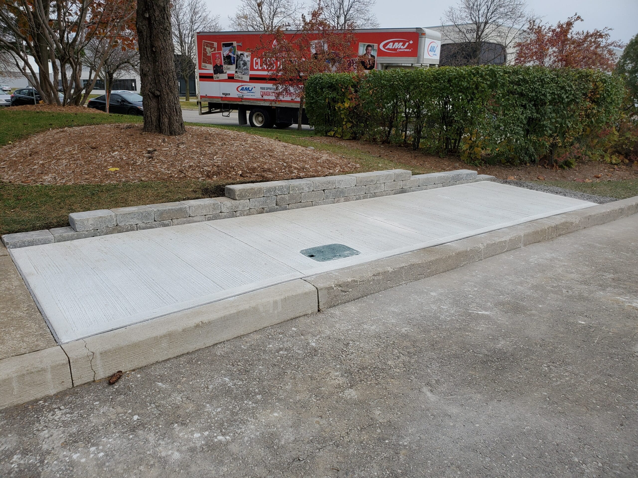 New concrete sidewalk with a mini retaining wall