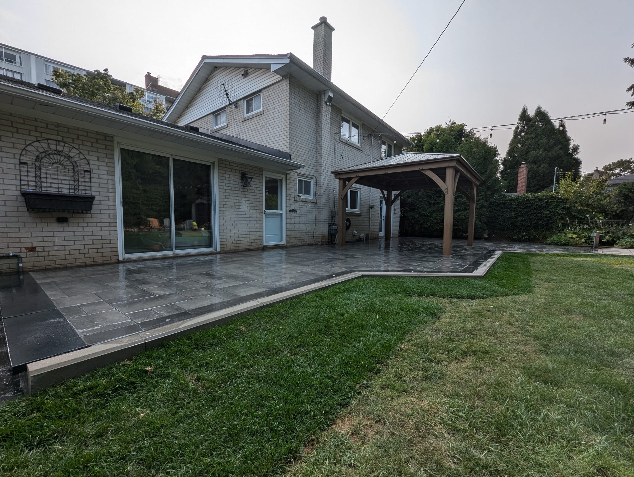 fresh sod installed around the outside of the patio