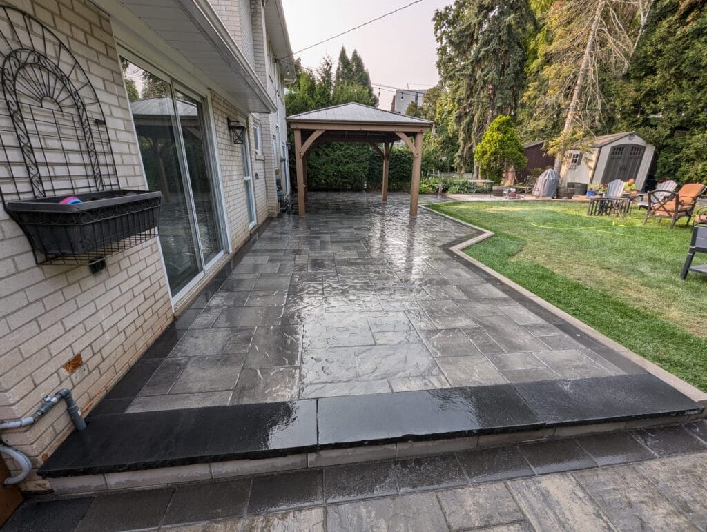 natural stone step which is going to a high end interlock backyard project