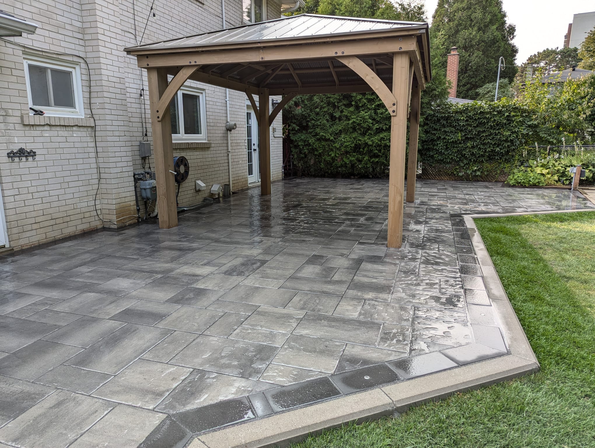 wet large modern paver patio with in ground led lighting