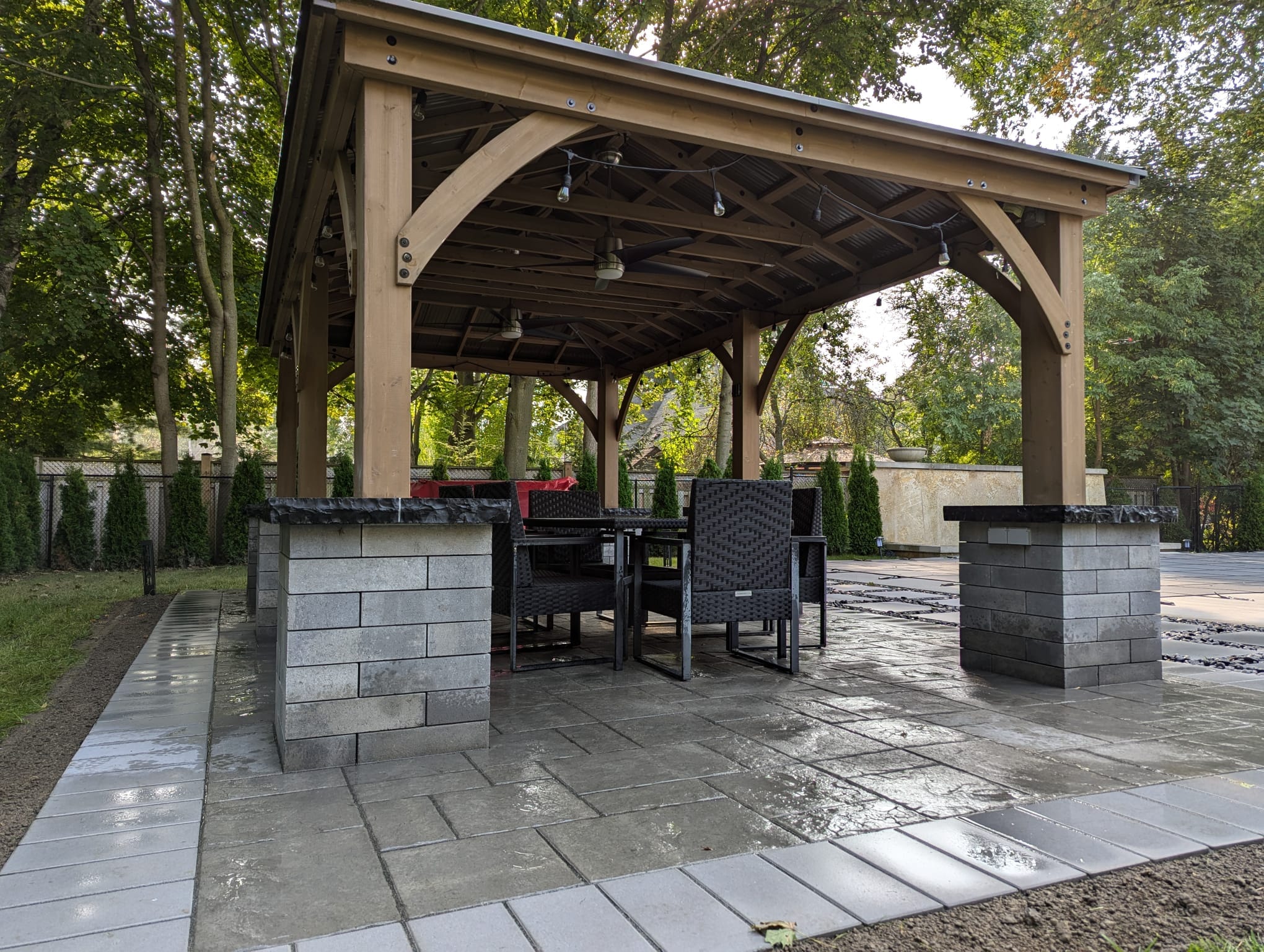 custom gazebo pillars with natural stone caps and ceiling fans