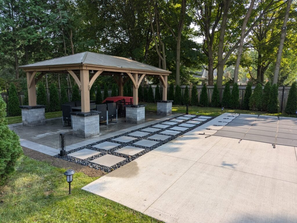 gazebo with large stepping stones surrounded by black polished decor stone