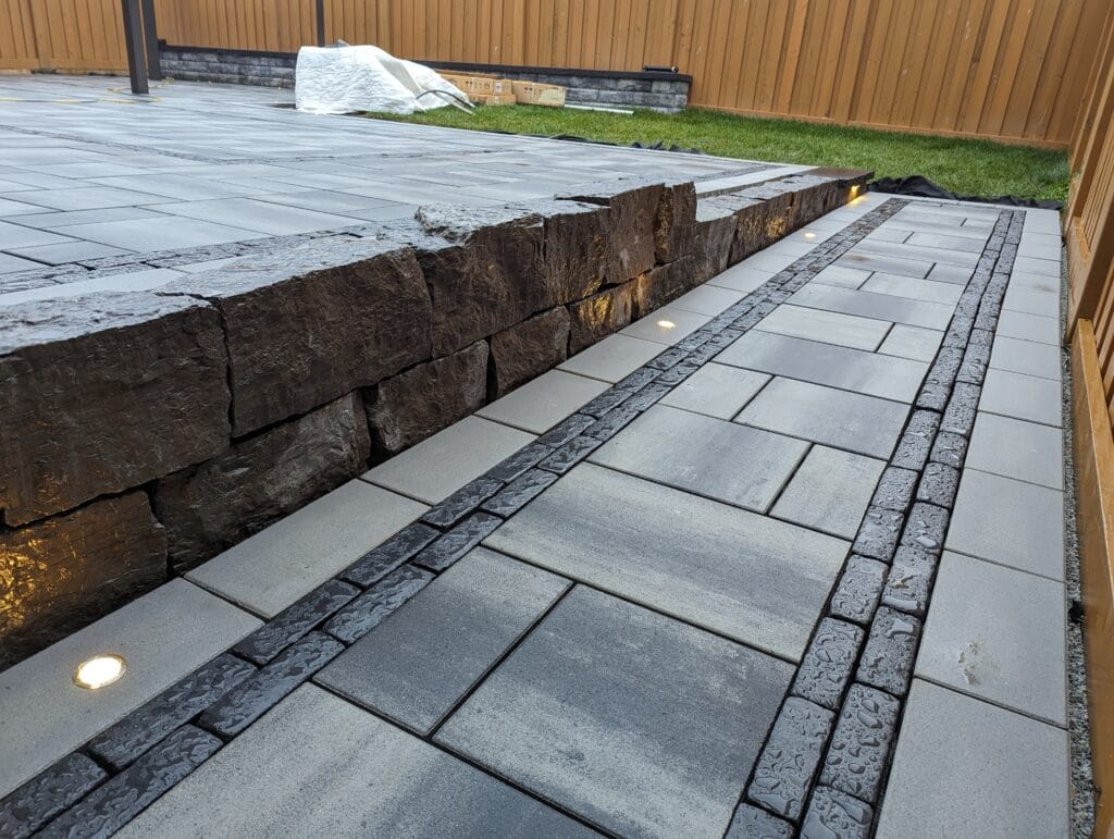 flush mount lighting in front of armour stone retaining wall