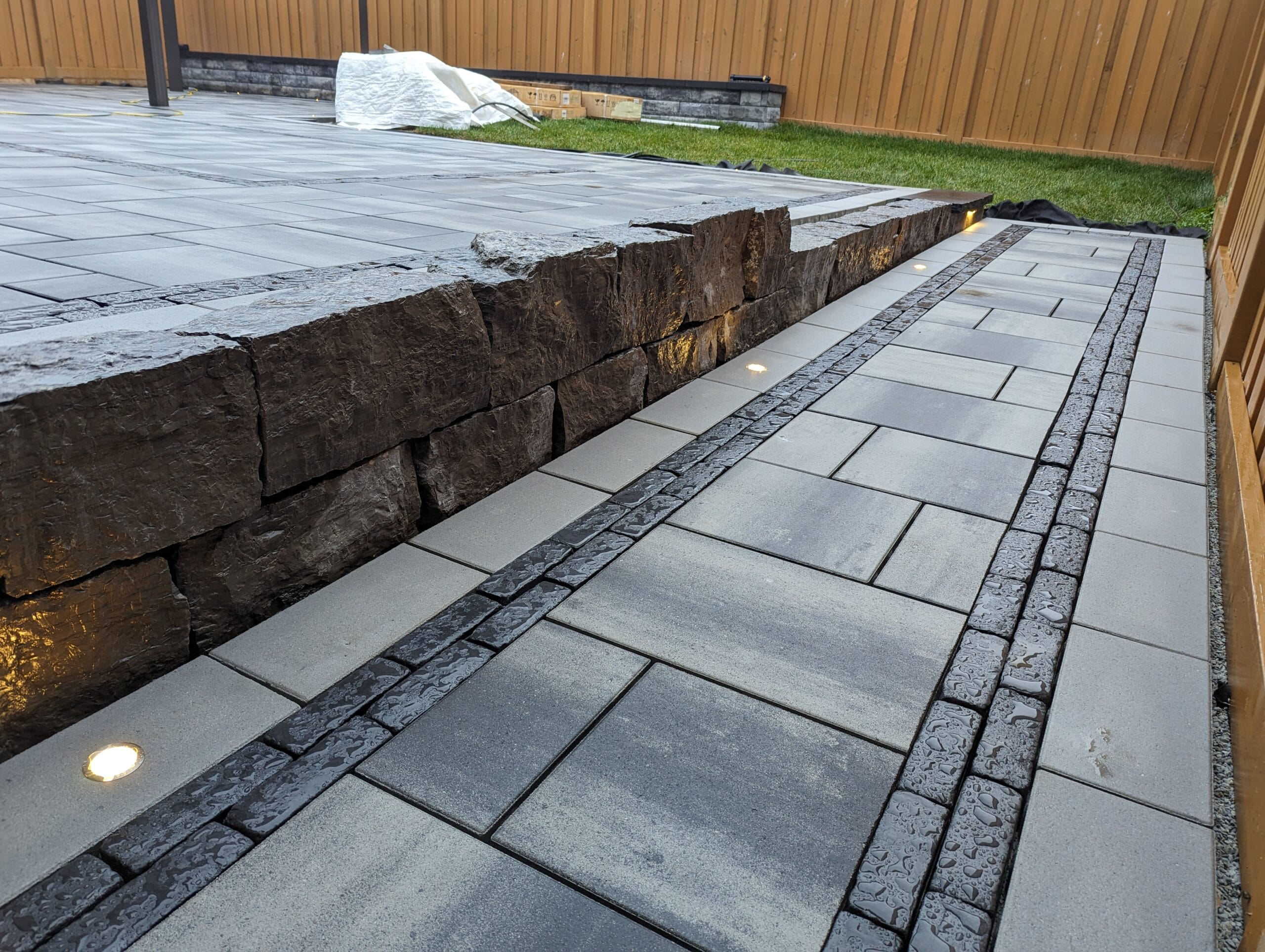 flush mount lighting in front of armour stone retaining wall