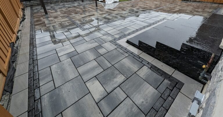 Natural stone steps installed into an interlock patio