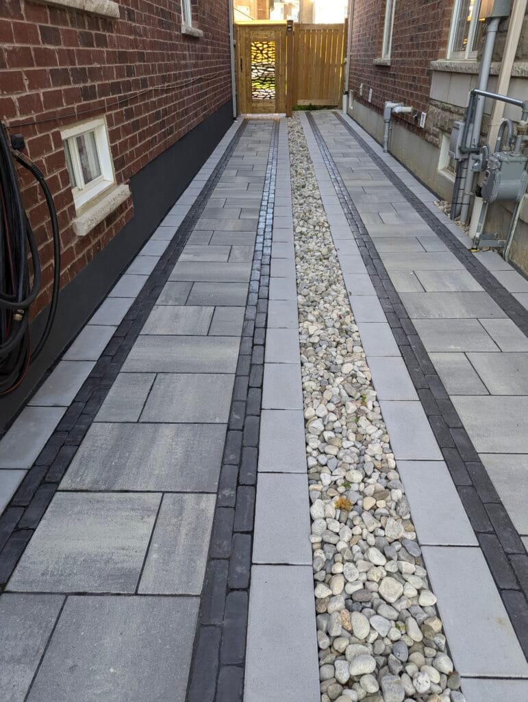 interlock pathways between 2 houses separated by river stone